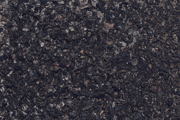 Asphalt texture, natural black pattern of roadway for design, grainy surface of pavement. Abstract dark wallpaper. Old weathered urban wall. Template with blank space.