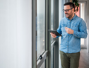 Happy businessman discussing while video conferencing on digital tablet.