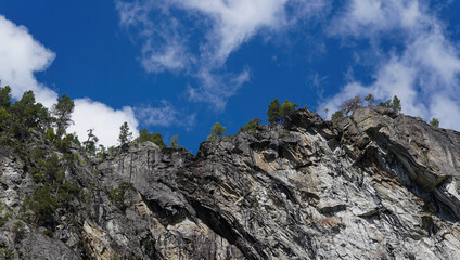 High cliff in the nature of Norway landscape with blue sky clouds in the background
