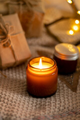 A set of different aroma candles in brown glass jars. Scented handmade candle. Soy candles are burning in a jar. Aromatherapy and relax in spa and home.