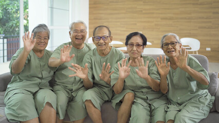Portrait of happy group of old elderly Asian patient or pensioner people smiling, relaxing, having fun together in nursing home. Senior lifestyle activity recreation. Retirement community. Health care