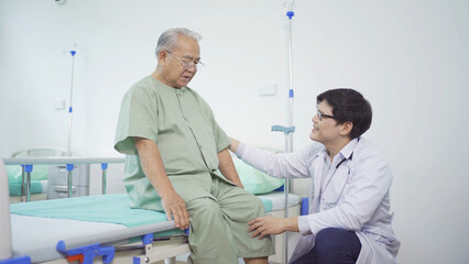 Obraz premium Happy old elderly Asian patient or pensioner and a doctor smiling, doing exercise, working out in nursing home in hospital. Senior people lifestyle activity recreation. Health care physical therapy.