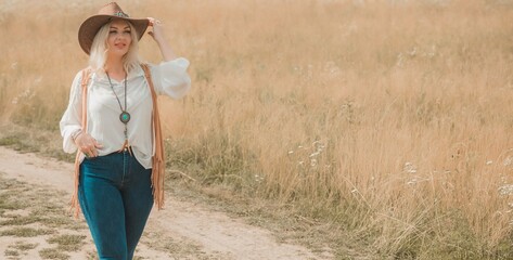 Woman Plus size in American country style black boho jacket, with a fringe, shirt and cowboy hat at nature © T.Den_Team