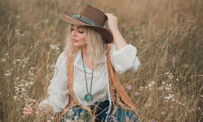 Woman Plus size in American country style black boho jacket, with a fringe, shirt and cowboy hat at...