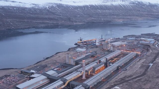 Massive industrial facility on fjord shore in east Iceland, aerial