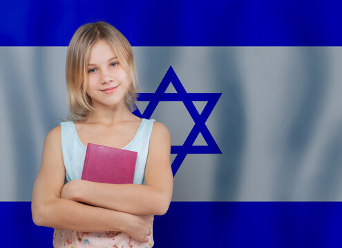 Education and school in Israel concept. Young girl smiling and holding book on Israeli flag background