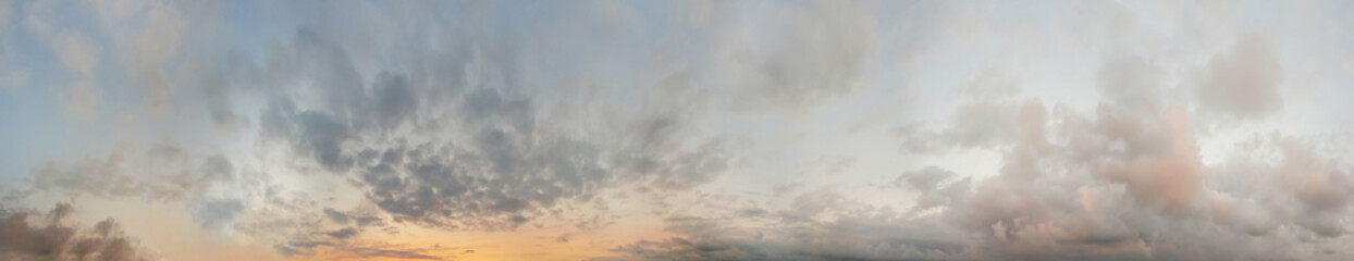 Fototapeta na wymiar Sunset sky. Panoramic landscape background with yellow sunlight, sky and dramatic fluffy clouds.