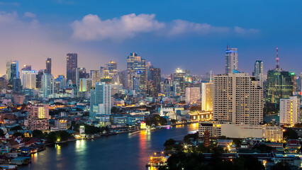 Naklejka premium Bangkok Transportation at Dusk with Modern Business Building along the river (Thailand)