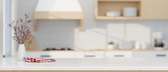 Modern luxury white kitchen tabletop with decors and copy space over blurred modern kitchen space