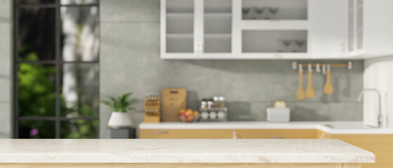 Fototapeta Copy space on modern marble kitchen tabletop over blurred modern home kitchen obraz