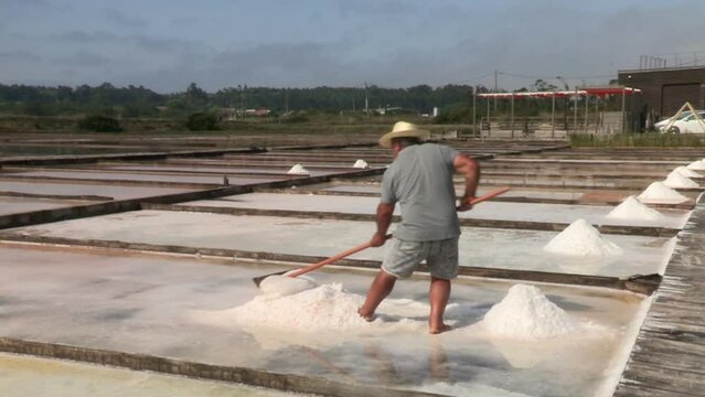 Man extracts salt from natural saline sea water.