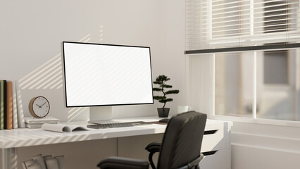 Minimal white home office workspace interior with PC desktop computer against the white wall.