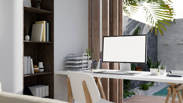 Modern luxury home office interior design with computer mockup and office supplies on the table