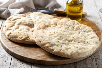 Italian focaccia with rosemary on wooden table