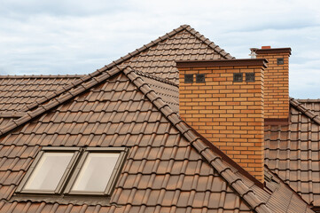 Roof with gutter waterproofing of a new house. Drainpipe fittings. Gutter system and roof protection on the roof of the house