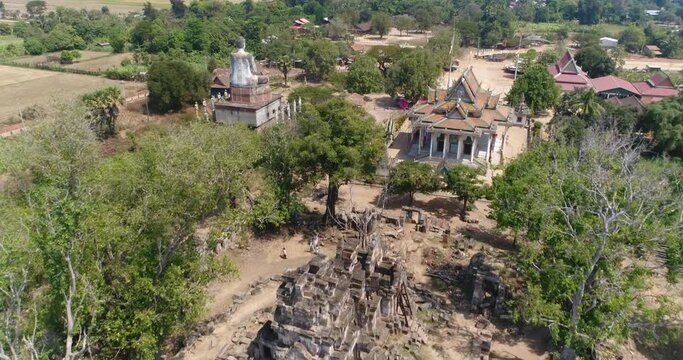 Aerial shot of Ek Phnom Temple, Pagoda and Buddha statue