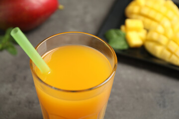 Fresh delicious mango drink on table, closeup