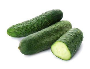 Whole and cut cucumbers on white background