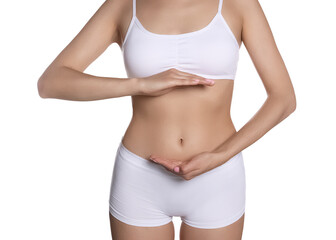 Fototapeta na wymiar Woman in underwear holding something near her belly on white background, closeup. Healthy stomach