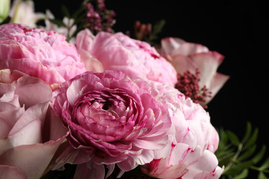 Beautiful bouquet of different flowers on dark background, closeup