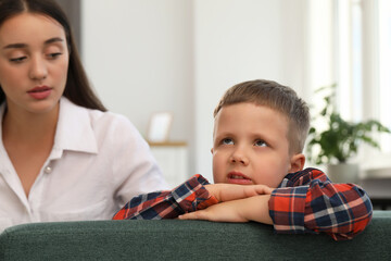 Psychologist working with unhappy little boy in office. Mental health problems