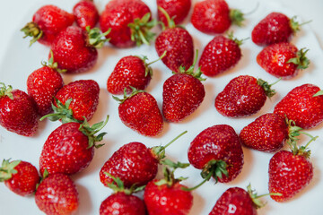 Obraz na płótnie Canvas a lot of red strawberries on a white background