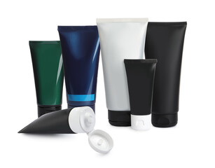 Set with tubes of facial cream on white background