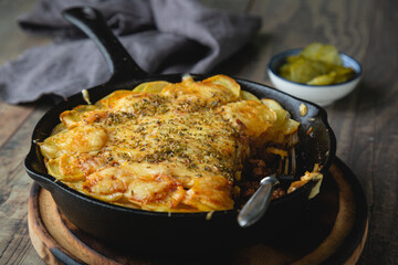Potato casserole with meat and cheese in a frying pan