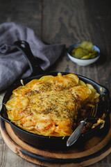 Potato casserole with meat and cheese in a frying pan