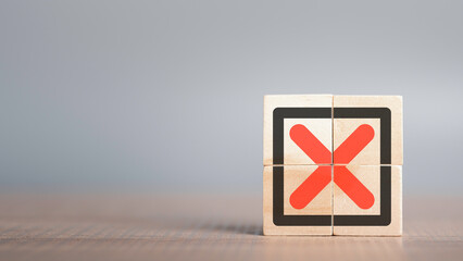 Red Cross mark, x, Wrong mark sign, Rejection sign in wooden cube stack. Concept of negative...