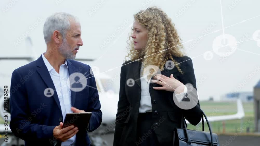 Sticker Animation of network of people icons over caucasian businessmen and businesswoman talking at airport