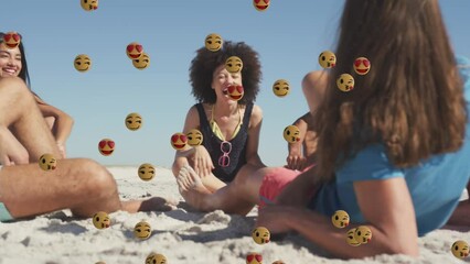 Animation of smiling and love emojis over diverse group of happy friends relaxing on sunny beach - Powered by Adobe