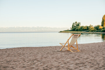 Deckchair on the sandy beach standing alone