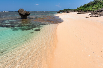 Incredible crystal clear sea waters with glistening surface, wavy sands at a paradise beach. Okinawa