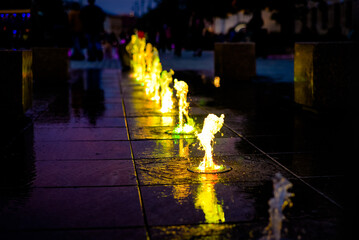 fountain in the night. A fountain at night, which has colored illumination