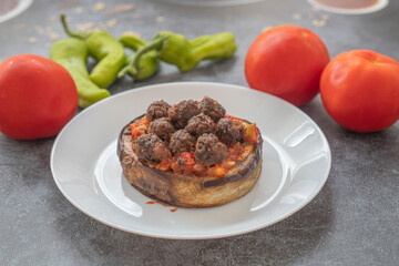 Meatballs on round eggplant. Eggplant dish with meatballs