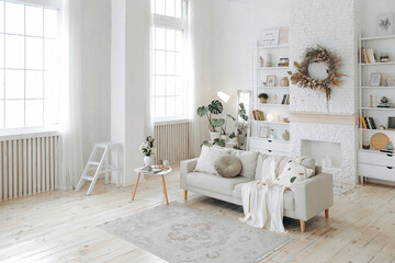 Modern stylish white living room with large windows and scandinavian style sofa against the...