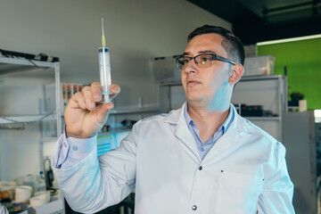 Male doctor holding a syringe in his hand