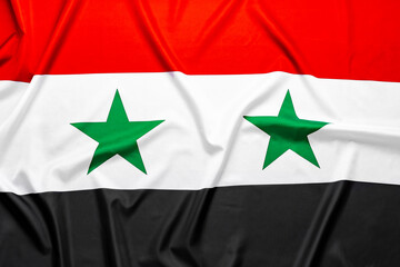 Wavy flag of Syria for background top view