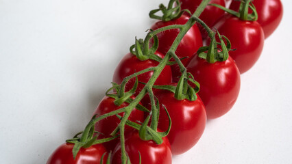 Vibrant close up of cherry tomatoes on vine. Recipes and food preparation concept.