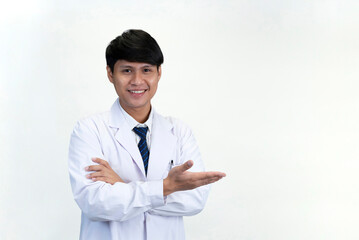 portrait young attractive doctor is doing hand sign welcome gesture, isolated on white background with copy space for text