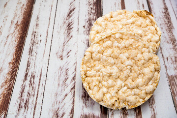 Round rice crackers on a rustic wooden table. Copy space. Healthy, natural food. Vegan food.