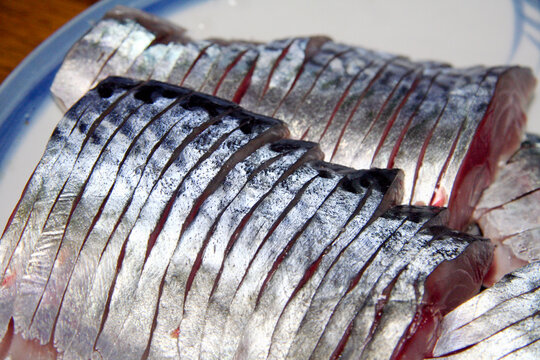 Japanese traditional sliced "pickled mackerel (Shimesaba)" using vinegar an seaweed dashi. Close up photograph.