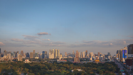 Obraz premium Panorama view of city landscape of modern skyscraper building and office tower in business district during sunset in the evening with clear blue sky. Bangkok metropolitan, capital city of Thailand.