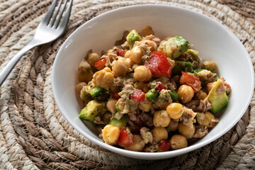 Fresh chickpea salad with tuna, tomato, pepper, onion and avocado