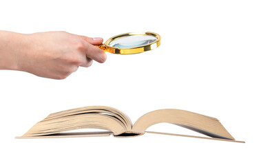 Hand holding magnifying glass over open book isolated on white background. Study and education...