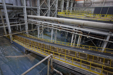 Special equipment with belt conveyor in factory workshop.