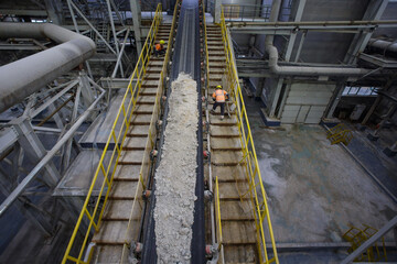 Special equipment with belt conveyor in factory workshop.