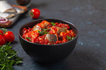 Herring fillet salad in tomato sauce.