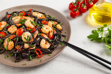Black pasta with roasted prawns.